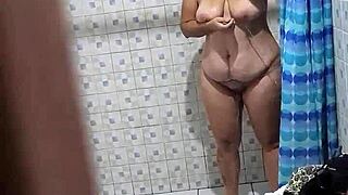 A mature Venezuelan woman is caught on camera while taking a shower by her mother-in-law