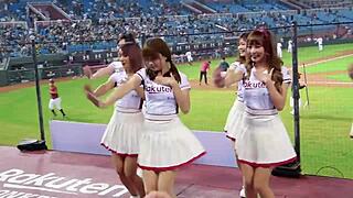 Cheerleaders in sexy uniforms cheer for the baseball team with enthusiasm