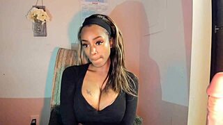 this tattooed ebony milf is playing with her big tits and pussy