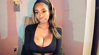 this tattooed ebony milf is playing with her big tits and pussy