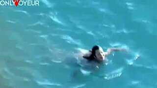 hot babe gives head on public beach, voyeur style