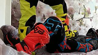 Motocross gay in biker costumes, boots treading on the action.