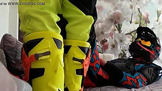 Motocross gay in biker costumes, boots treading on the action.