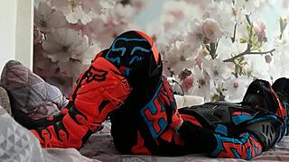 Motocross gay in biker costumes, boots treading on the action.