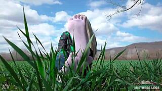 Adoring her cute feet in white socks on spring grass with jeans.