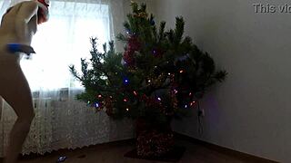 bitch with small tits dances around christmas tree showing ass and pussy