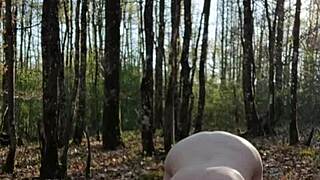 female slave performs outdoor self-session in bizarre setting