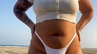 Redhead Exhibitionist Flashes Swollen Pussy On Beach While Muscular Man Receives Sloppy Blowjob