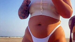 Redhead Exhibitionist Flashes Swollen Pussy On Beach While Muscular Man Receives Sloppy Blowjob