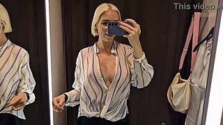 Trying on sexy see-through outfits in dressing room.
