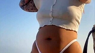 Redhead Exhibitionist Flashes Swollen Pussy On Beach While Muscular Man Receives Sloppy Blowjob