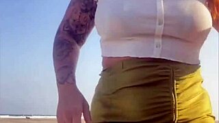 Redhead Exhibitionist Flashes Swollen Pussy On Beach While Muscular Man Receives Sloppy Blowjob