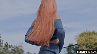 sexy redhead relaxes with her partner in a casual session