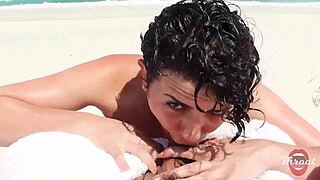 The naughty brunette gave me a blowjob on the beach in front of the bathers.