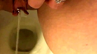 Pretty pierced pussy peeing solo in the bathroom toilet