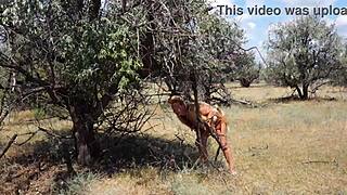 shy aboriginal woman dances in costume outdoors
