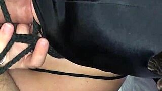 Bound and masked woman sucking cock in bondage.