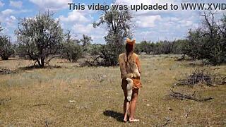 shy aboriginal woman dances in costume outdoors