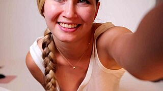 Flexible babe spreads legs wide on soft couch for intense self-pleasure.