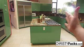 Christy Mack teases her big tits and wet pussy on the kitchen counter.