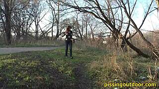 a person pissing outdoors in a secure location for fetish purposes