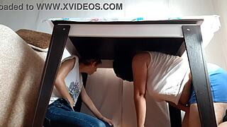 two brunette lesbians hide under the desk in jeans and miniskirts to masturbate passionately