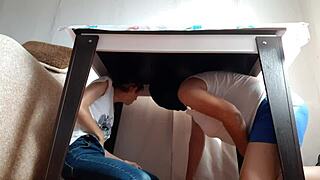 two brunette lesbians hide under the desk in jeans and miniskirts to masturbate passionately