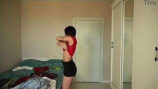 Pretty teen tries on new clothes including skirts, pants, tops, and blouses.