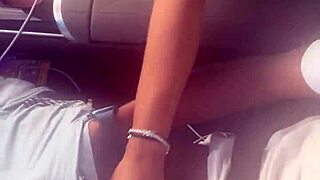 In the car, she plays with a big black cock, giving a blowjob outdoors