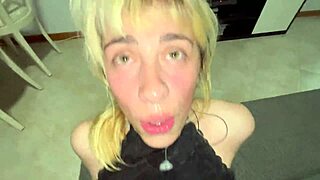 pretty woman in bdsm scene worships lover's dick