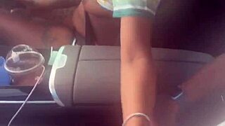 In the car, she plays with a big black cock, giving a blowjob outdoors