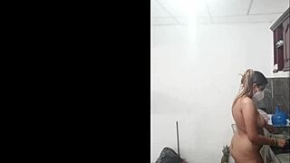 cute tall woman cooks naked in kitchen