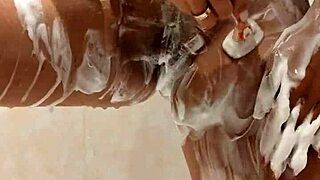 Milf gets naked in the shower, revealing big tits while bathing sensually in private moment.