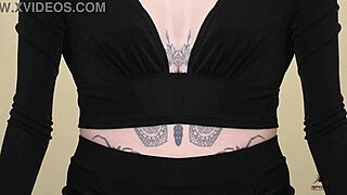 Young babe Kit Summers models two-piece black outfit with deep plunging neck in photoshoot