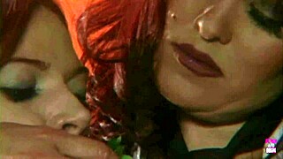 Hey, watch this redheaded lesbian babe forcing the big breasted lady to eat cakes and fruit!