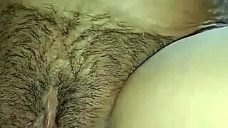 Boyfriend passionately fingers oiled hairy pussy of hot masturbating girl in intimate moment.