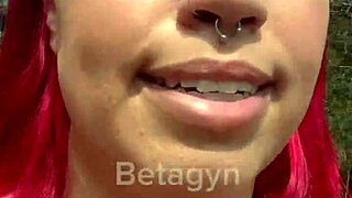 A young amateur couple engages in a quick public encounter in the park, embracing the thrill of the outdoors.