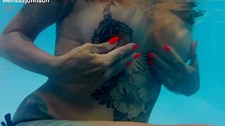 melissa the mermaid shows brown eyes and tattoo by the pool in milf solo scene