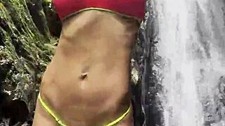 Monika Fox Walks Through Jungle In Pink Top Yellow Shorts Showing Big Tits Pierced Nipples Naked