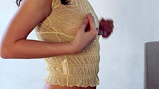 dark haired young beauty undresses sensually touching shaved body in mirror