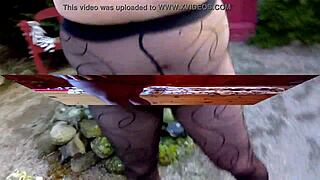 german amateur teases pussy legs in black pantyhose outdoors