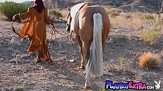 Petite redhead Odette Fox bares big natural tits pussy on horse