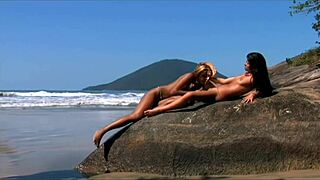 Young lesbians lick and toy tight shaved pussies seaside