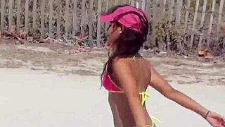 Young bikini babe teases voyeurs on crowded beach