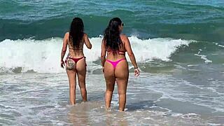 two sexy brazilian brunettes kiss on cabo beach publicly