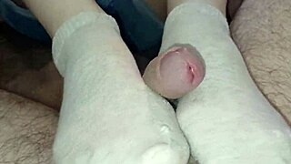 homemade teen footjob in socks ends with cum-soaked toes and orgasmic mess on bed