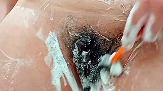 young brunette shaves her hairy pussy closeup in bathroom