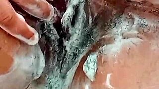 young brunette shaves her hairy pussy closeup in bathroom