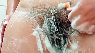 young brunette shaves her hairy pussy closeup in bathroom