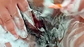 young brunette shaves her hairy pussy closeup in bathroom